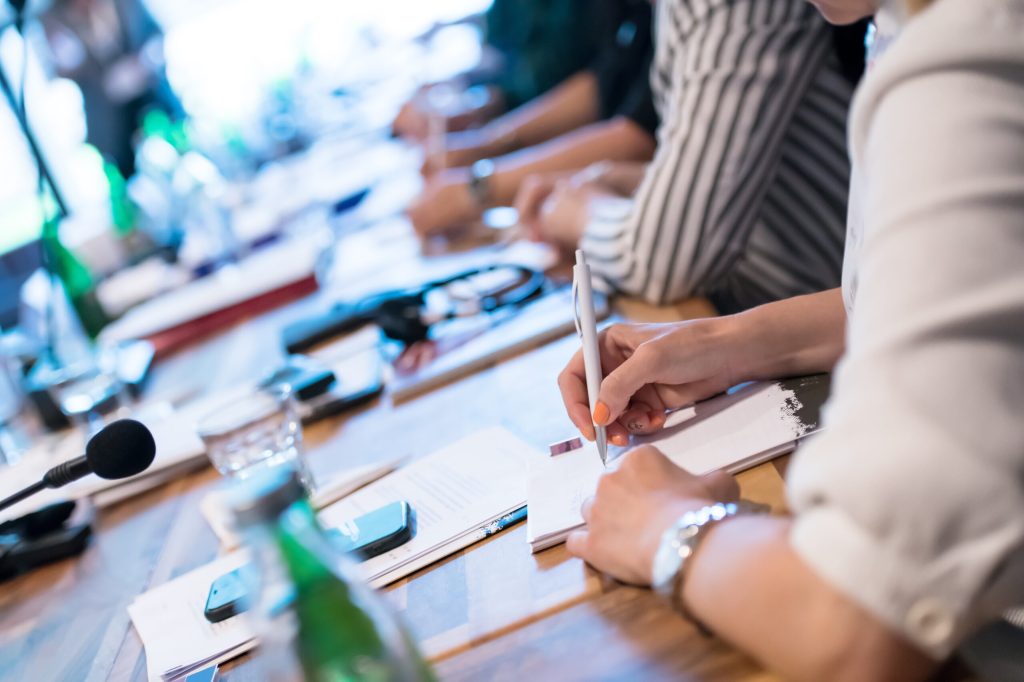 close up of business people taking notes