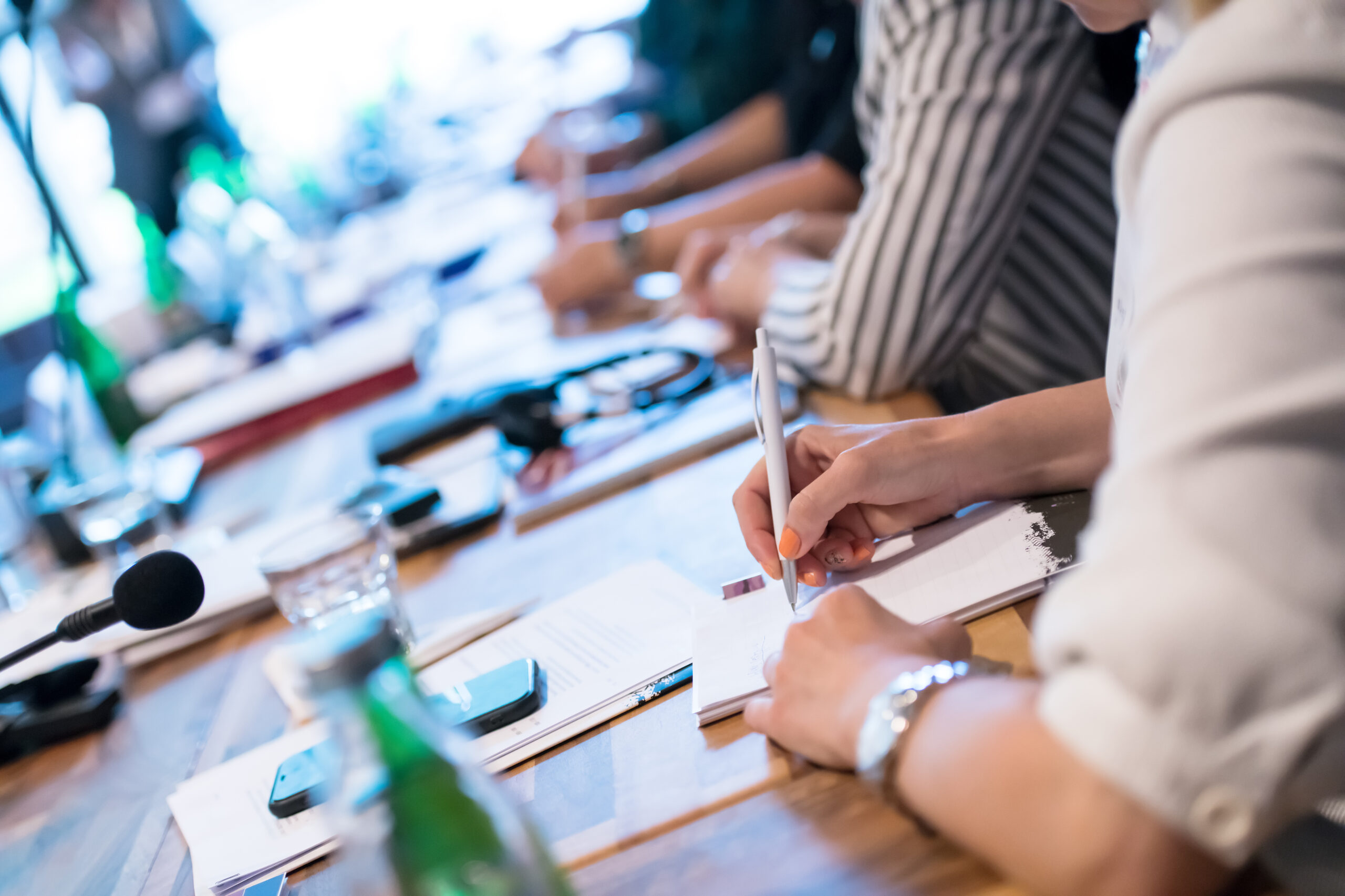 close up of business people taking notes